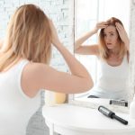 Concern in the mirror over thinning hair.