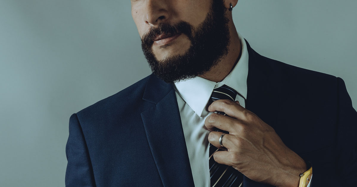 Well dressed man with a well kept beard.