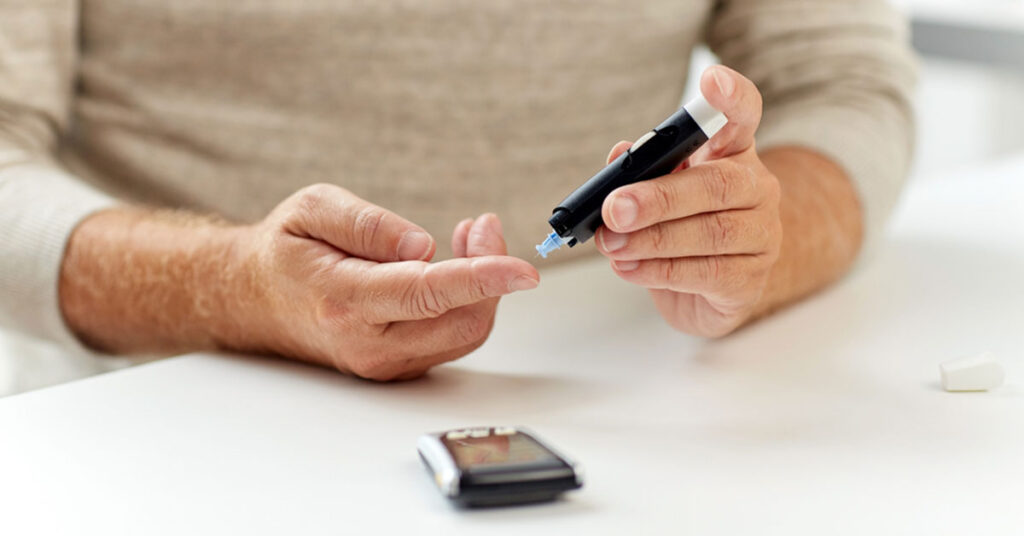 Male with diabetes pricking his finger