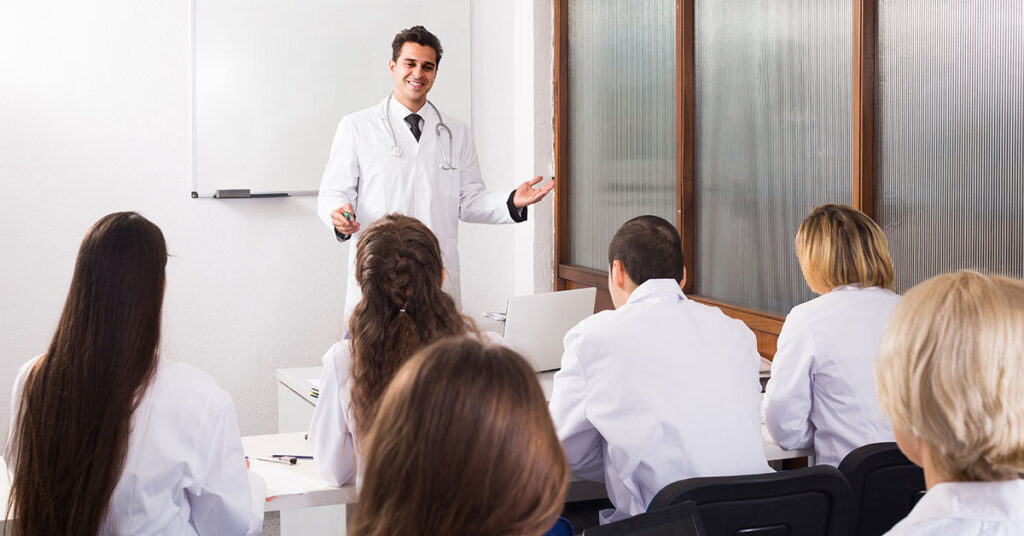 Professor teaching classroom about robotic hair restoration with ARTAS