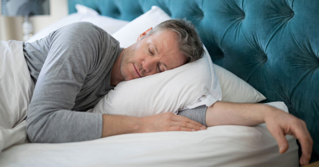 an older man with healthy hair sleeping