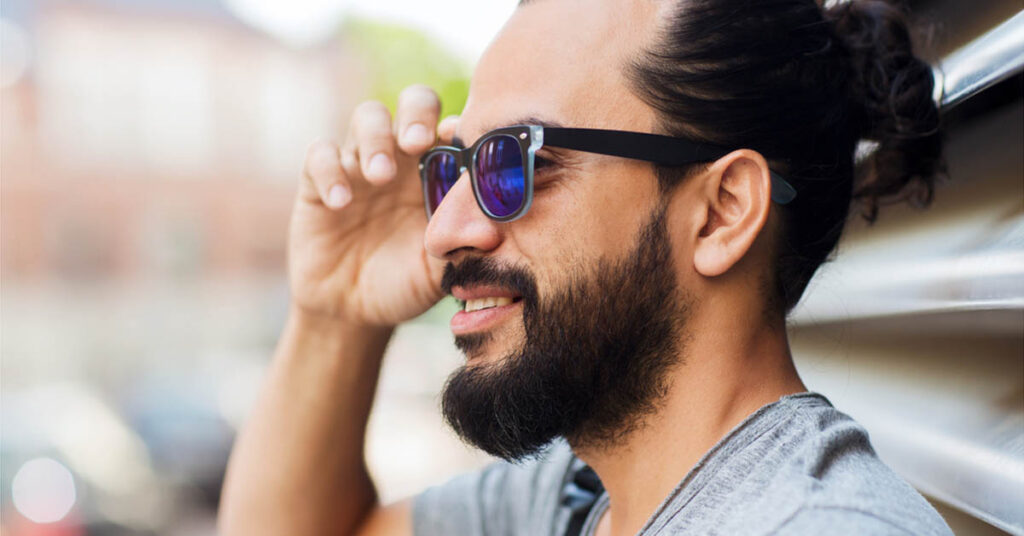 man with a tight man bun hairstyle