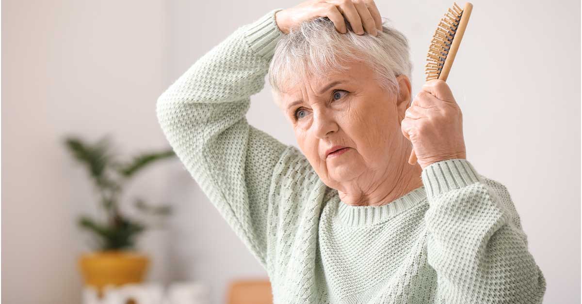 Woman with gray hair experiencing hair loss