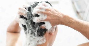 man washing hair with baby shampoo