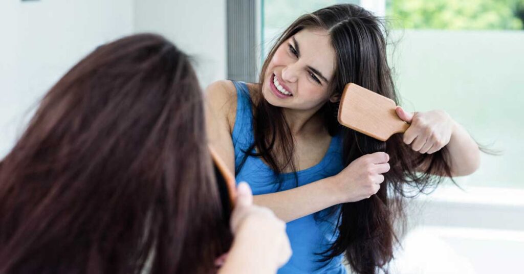 woman brushing her hair