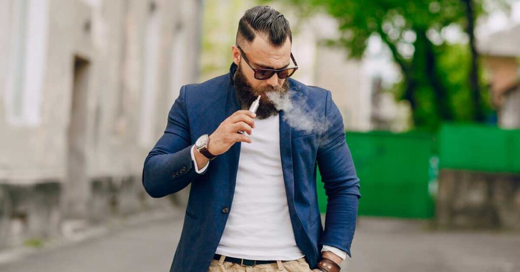 man smoking a vape